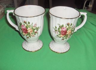 Up for sale are 2 beautiful footed, fluted mugs (5 5/8”) by Royal
